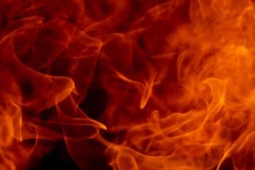 Abstract fire flame glowing burning on black dark background, photo for creative graphic design wallpaper, beautiful flame light motion of bonfire