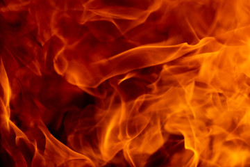 Abstract fire flame glowing burning on black dark background, photo for creative graphic design wallpaper, beautiful flame light motion of bonfire