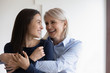 Happy mature mother hug cuddle grown-up beautiful daughter enjoy spending time together, smiling senior mom embrace adult girl child show love and care, family good relationships concept