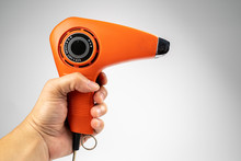 Vintage Orange Hair Dryer On White Background With Rolled Cable Buttom.