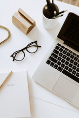 Wall Mural - Home office desk workspace with laptop, notebook, glasses on white table. Flat lay, top view minimal women's, girl boss background.