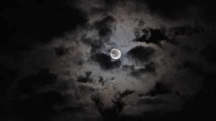 Wall Mural - full moon moving between clouds, 4k