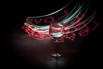 Goblet of white wine on wooden table on wooden wall background