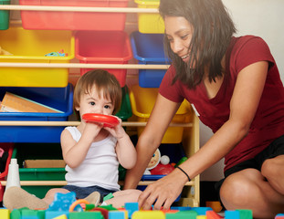 Babysitter and kid play together