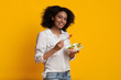 © Prostock-studio - Smiling Afro Woman Eating Fresh Vegetable Salad Standing On Yellow Background