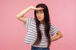 © khosrork - Portrait of young ambitious pretty girl with long hair holding head over eyes and looking into distance with attentive expression, planning future. indoor studio shot isolated on pink background