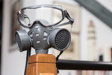Coronavirus Concept: Close Up On A Gas Mask Placed Inside A Domestic Interior.