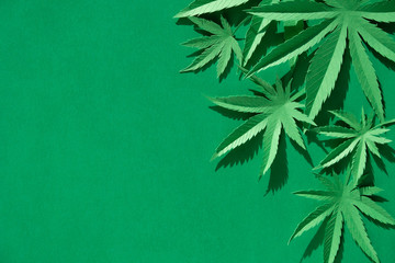 Cannabis leaf made of paper on green background