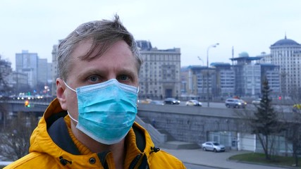 Wall Mural - Sick man in medical mask outdoors