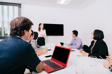 Wall Mural - Group of office workers at a meeting around the boss