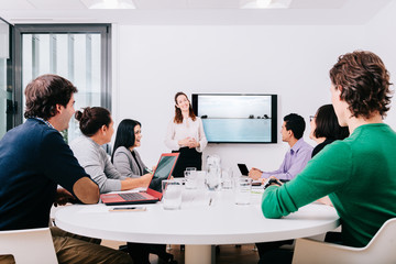 Wall Mural - Group of office workers at a meeting around the boss