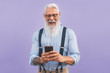 © Alessandro Biascioli - Senior man using mobile smartphone and listening music with airpods - Happy mature male having fun with new trends technology social media apps - Elderly lifestyle people and tech addiction concept