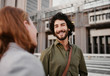 © StratfordProductions - Portrait of successful and laughing business man in conversation with female partner on city street