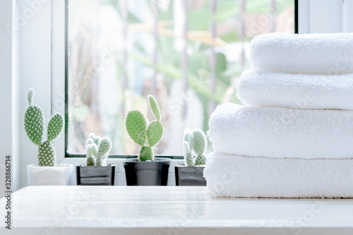 Fotomural Clean towel on white table near window sill.