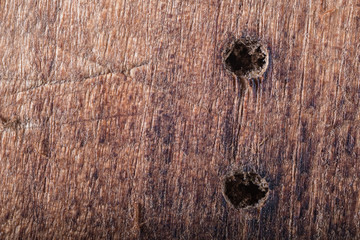 old wooden background with two holes. macro. horizontal