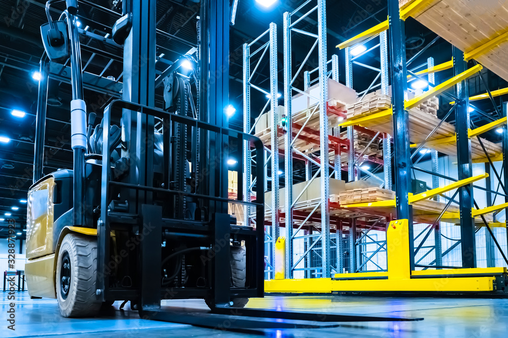 Warehouse Using Loading Tools Loader in the warehouse. Forklift rides through the warehouse. Forklift ...