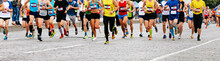 Large Group Of Runners Athletes Run City Marathon On Cobblestones