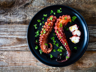 barbecue octopus on wooden table