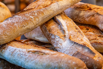 Close up of stack of traditional baked french baguettes on a market stall