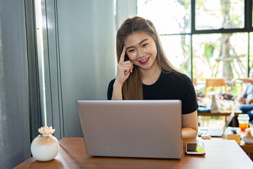 Wall Mural - Beautiful Attractive Asian woman working with computer laptop and thinking to get ideas and requirement in Business startup feeling so happiness,Business Startup Concept