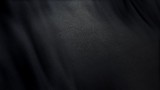 black flag cloth in full frame with selective focus. 3D Illustration of pitch-dark colored garment with clean natural linen texture for background banner or wallpaper use.