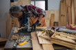 © chokniti - The carpenter is using the tools to work in the wooden studio.