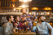 © Studio Romantic - A group of guys watching sports on tv in a pub bar.