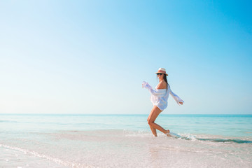 Poster - Woman on the beach enjoying summer holidays looking at the sea