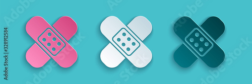Fotografía Paper cut Crossed bandage plaster icon isolated on blue background