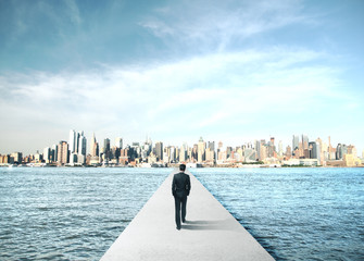 Wall Mural - Businessman walking to modern city