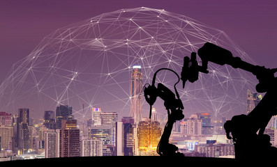 Leinwandbilder - Silhouette of modern automation robot arms with Ai assistant technology network concept and metropolis city building background.