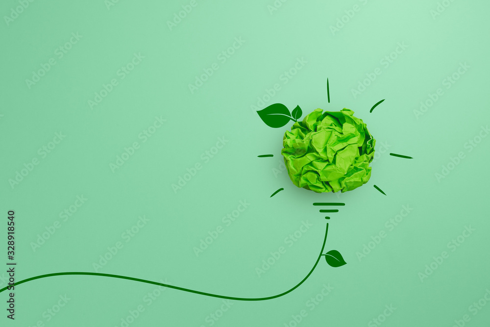Green crumpled paper light bulb on green background, Corporate Social Responsibility (CSR), eco-friendly business and environmental concept - obrazy, fototapety, plakaty 