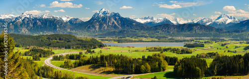 Fotomural panoramic landscape with meadow and lake in front of alps mountains