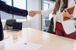 Friendly handshake between recruiter and new woman intern at the end of successful candidate selection process