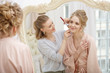© Miramiska - Makeup artist, hair professional stylist makes young beautiful bride bridal makeup before wedding in a morning