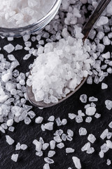 coarse sea salt on a dark stone background