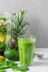 Ingredients for cooking healthy detox green smoothie in blender with glass of smoothie. Vegan cooking concept