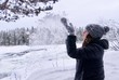 © Tamara Sushko - Girl playing with a snow on Storforsen background, biggest  waterfall in  Swedish Lapland Europe