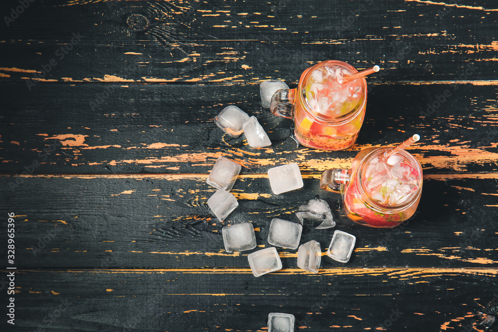 Mason jars of cold tea on dark wooden table