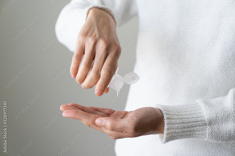 Female hands using hand sanitizer isolated white background - obrazy, fototapety, plakaty 