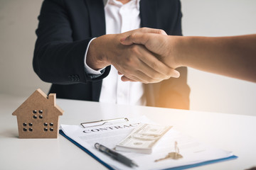 Wall Mural - Home sales agents and buyers work on signing new homes and shaking hands.