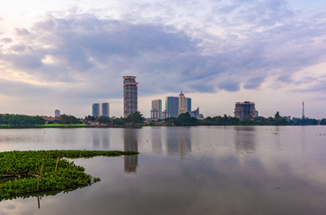 Wall Mural - Tangerang, Indonesia - 5th January 2018: A view of Danau Kelapa Dua (Kelapa Dua Lake) on the foreground and Lippo Karawaci district buildings in the background. Taken in a cloudy afternoon.