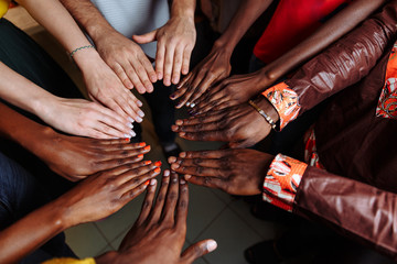 Wall Mural - Hands of happy group of African Latin American and European people which stay together in circle