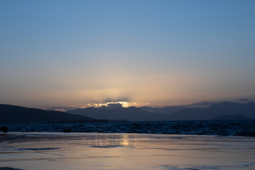 Sunset on aegina island in greece with clouds