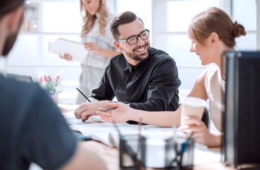 Poster - employees discussing ideas for a new project.