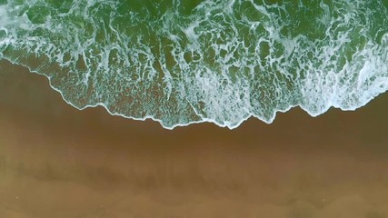 Wall Mural - Tropical beach water background. Soft wave of emerald clear sea on sandy beach