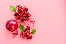 Ripe Pomegranate Fruit Near Leaf On Pink Background Top-down Copy Space