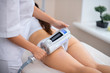 © zinkevych - Massage specialist using modern equipment for ultrasound massage