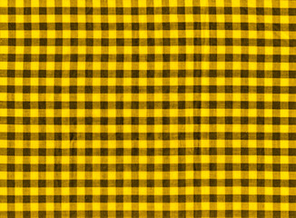 The texture of the bright yellow of binding gingham fabric. Yellow textile background. Fabric plaid. Close-up