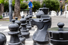 Outdoor Chess Board With Big Plastic Pieces. Outdoor Giant Chess In Public Area Zone, Close Up Big Pieces Of Street Chess In The Park